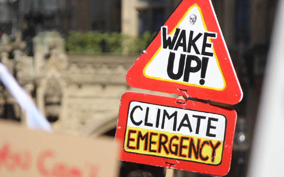 Wake Up On Danger Sign With Climate Emergency On Other Sign