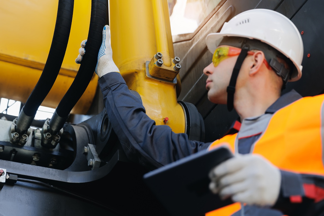 Male engineer inspecting machinery 2761679299