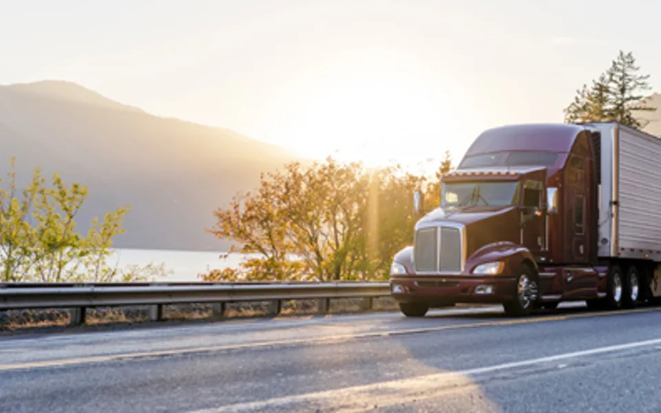 Truck On Road Beside Lake