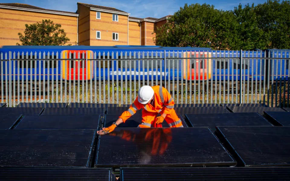 Person Wiping Solar Panel