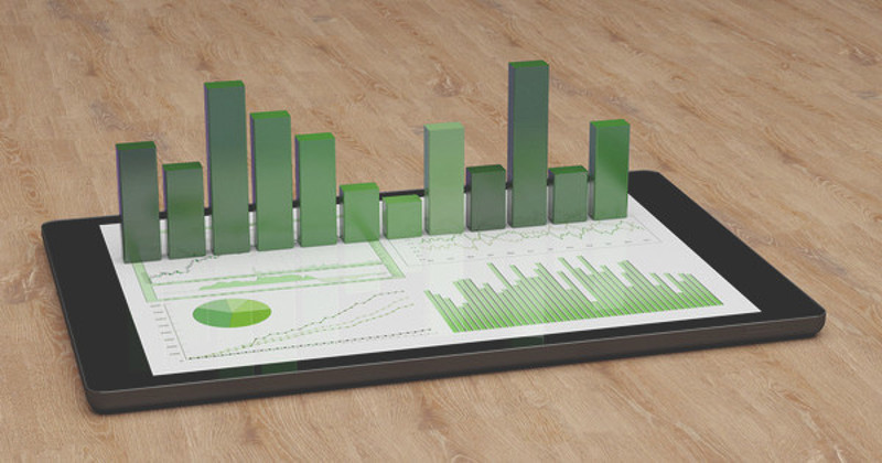 Green bar graph standing above other graphs on a tablet device