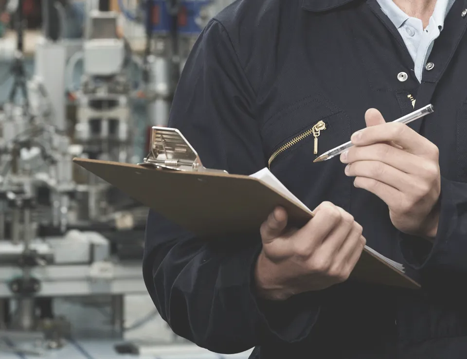 Man With Clipboard Inspecting Machine