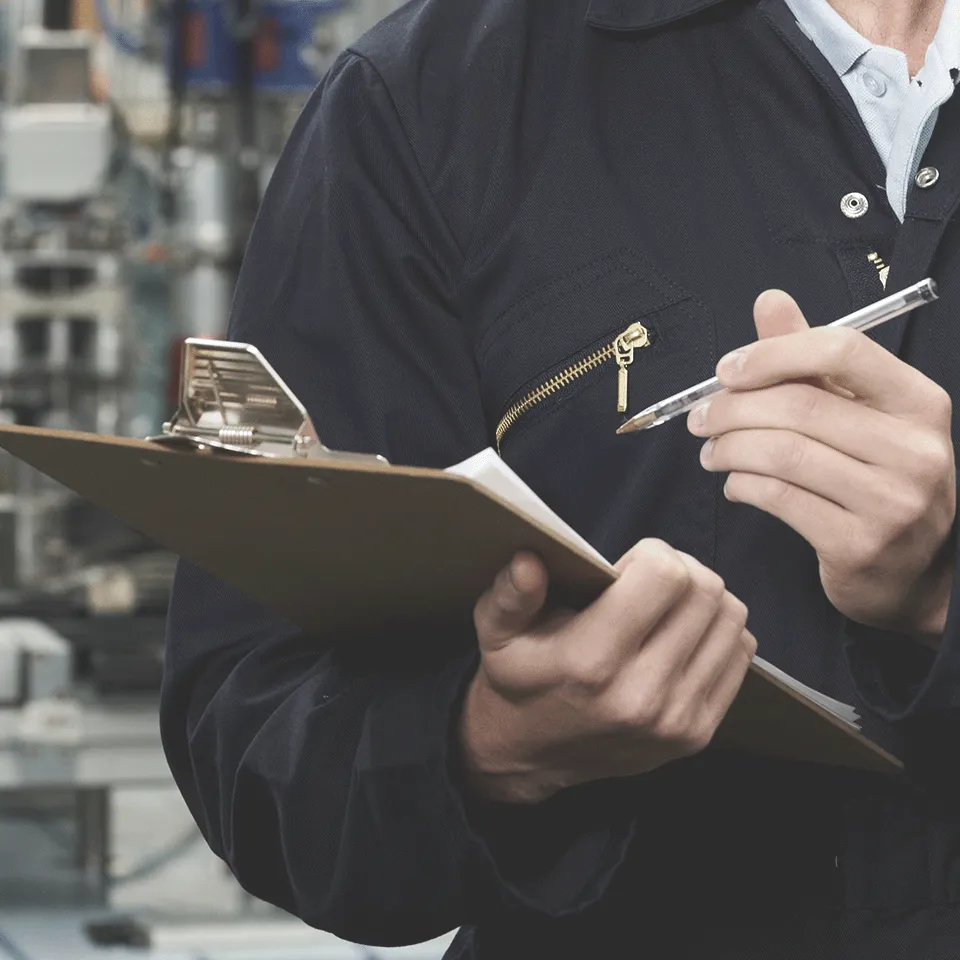 Man With Clipboard Inspecting Machine