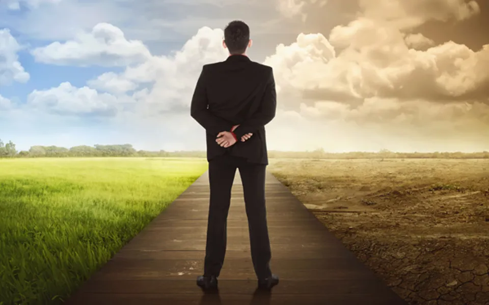 Man Standing Middle Of Fertile Land And Infertile Land