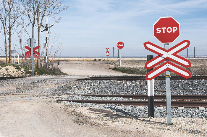 Remote railway level crossing / grade crossing with only a stop sign for protection (no signals or bells).